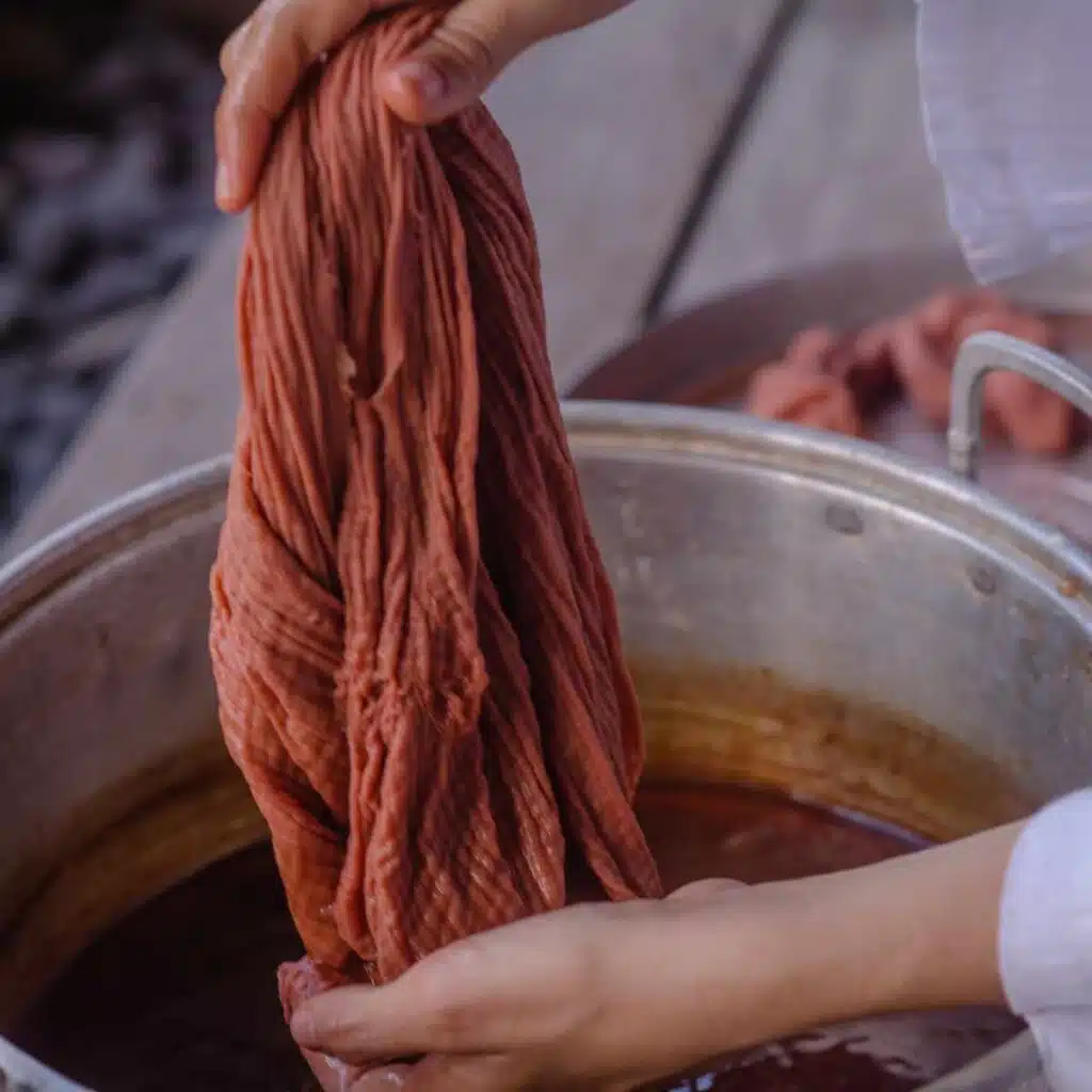 Fabric being dyed with natural dye.